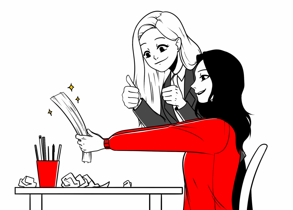 Dwie kobiety przy biurku, jedna trzyma tekst z uśmiechem i pokazuje kciuk w górę – współpraca nad scenariuszem animacji